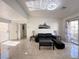 Spacious and bright living room with tile floors, leading to the kitchen, and a view of the front entry at 8452 Boseck Dr # 225, Las Vegas, NV 89145