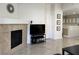 View of living room with tile floors, fireplace, and view into the bright dining area at 8452 Boseck Dr # 225, Las Vegas, NV 89145