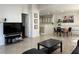 Open-concept living room with tile floors, a TV, and a view into the kitchen and dining space at 8452 Boseck Dr # 225, Las Vegas, NV 89145
