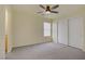 Bright bedroom with a ceiling fan, neutral carpet, and a spacious closet at 9932 Keephills St, Las Vegas, NV 89183