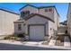 Two-story home with a garage and a well-maintained front yard at 9932 Keephills St, Las Vegas, NV 89183