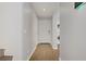 Hallway with wood-look floors and access to laundry area and front door at 9932 Keephills St, Las Vegas, NV 89183