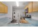 Clean, modern kitchen with stainless appliances and a unique backsplash and sink area at 9932 Keephills St, Las Vegas, NV 89183