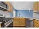 Modern kitchen with stainless steel appliances, a gas range, and light wood cabinetry at 9932 Keephills St, Las Vegas, NV 89183