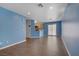 Large, open living area with hardwood floors and bright blue walls at 9932 Keephills St, Las Vegas, NV 89183