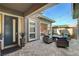 Charming back patio featuring stone pavers, an outdoor seating area, and string lights at 10004 Terrastone Dr, Las Vegas, NV 89148