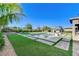 Expansive backyard oasis featuring a pristine pool, lush landscaping, and an inviting outdoor kitchen perfect for entertaining guests at 10004 Terrastone Dr, Las Vegas, NV 89148