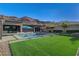 Beautiful backyard featuring a sparkling pool, spacious lawn, and seamless connectivity to the home's inviting indoor spaces at 10004 Terrastone Dr, Las Vegas, NV 89148