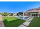 Well-manicured backyard showcasing a modern pool, outdoor kitchen, and a seamless blend of indoor-outdoor living space at 10004 Terrastone Dr, Las Vegas, NV 89148