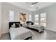 A clean and modern bedroom features two twin beds, ceiling fan and window shutters at 10004 Terrastone Dr, Las Vegas, NV 89148