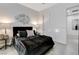 Stylish bedroom with modern art, side tables, and door leading to the bathroom at 10004 Terrastone Dr, Las Vegas, NV 89148