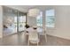 Bright breakfast nook featuring a round table, plantation shutters, and a sliding glass door to the patio at 10004 Terrastone Dr, Las Vegas, NV 89148