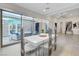 Bright dining area with modern white table and chairs, opens onto a patio at 10004 Terrastone Dr, Las Vegas, NV 89148