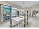 Modern dining area featuring a white table and chairs, with access to the outdoor patio at 10004 Terrastone Dr, Las Vegas, NV 89148