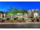 Modern home exterior with well-maintained landscaping and a stone accent wall at 10004 Terrastone Dr, Las Vegas, NV 89148