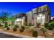 Attractive home exterior at night featuring manicured landscaping and modern design at 10004 Terrastone Dr, Las Vegas, NV 89148