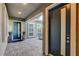 Covered front porch with stone pavers, views of the home's courtyard and outdoor furniture at 10004 Terrastone Dr, Las Vegas, NV 89148