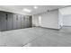 Large garage with sealed floors and storage cabinets installed on the wall at 10004 Terrastone Dr, Las Vegas, NV 89148