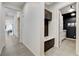 Hallway with neutral tile flooring, leading to the kitchen and the living room at 10004 Terrastone Dr, Las Vegas, NV 89148