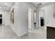Long hallway with neutral tiling and paint that provides access to the various bedrooms at 10004 Terrastone Dr, Las Vegas, NV 89148