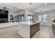 Open concept kitchen featuring modern lighting, a large island, and a view of the living room at 10004 Terrastone Dr, Las Vegas, NV 89148