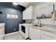 Laundry room featuring white cabinets, a sink and modern appliances at 10004 Terrastone Dr, Las Vegas, NV 89148