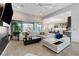 Open living room with sleek, modern furniture, recessed lighting, and access to the outdoor patio at 10004 Terrastone Dr, Las Vegas, NV 89148