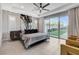 Spacious main bedroom with a ceiling fan, large windows, and access to the backyard at 10004 Terrastone Dr, Las Vegas, NV 89148