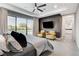 Luxurious main bedroom with a ceiling fan, TV, seating area, and pool view at 10004 Terrastone Dr, Las Vegas, NV 89148