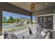 Inviting covered patio featuring modern furniture and a seamless transition to the backyard oasis with a pool and outdoor kitchen at 10004 Terrastone Dr, Las Vegas, NV 89148