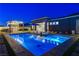 Luxury pool and spa with outdoor kitchen, lounge seating, and beautifully landscaped backyard at 10004 Terrastone Dr, Las Vegas, NV 89148