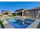 Stunning pool and outdoor kitchen area with ample seating perfect for entertaining at 10004 Terrastone Dr, Las Vegas, NV 89148