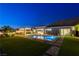 Beautiful backyard with pool, spa, outdoor kitchen and lush landscaping, ideal for outdoor living at 10004 Terrastone Dr, Las Vegas, NV 89148