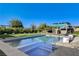 Beautiful pool with artificial turf and outdoor kitchen under a pergola at 10004 Terrastone Dr, Las Vegas, NV 89148