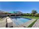 Inviting pool area featuring modern bench seating and lush landscaping at 10004 Terrastone Dr, Las Vegas, NV 89148