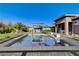 Refreshing backyard pool with lush landscaping and an outdoor kitchen for entertaining at 10004 Terrastone Dr, Las Vegas, NV 89148