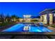Elegant pool and spa with outdoor kitchen, lounge seating, and manicured backyard, perfect for entertaining at 10004 Terrastone Dr, Las Vegas, NV 89148