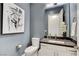 Stylish powder room featuring a dark countertop and modern decor at 10004 Terrastone Dr, Las Vegas, NV 89148