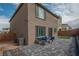 Landscaped backyard with stone pavers, seating area, and small patch of lawn at 10189 Magnolia Creek St, Las Vegas, NV 89141