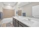 Bright bathroom with a double sink vanity, bathtub, and neutral tile shower surround at 10189 Magnolia Creek St, Las Vegas, NV 89141