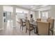 Open concept dining area with a large table, seating for six, and views of the living space at 10189 Magnolia Creek St, Las Vegas, NV 89141