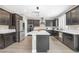 Beautiful kitchen featuring dark cabinets, white countertops, stainless steel appliances, and a stylish island at 10189 Magnolia Creek St, Las Vegas, NV 89141
