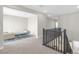 Open loft area with plush carpeting, modern furnishings, and a view of the staircase at 10189 Magnolia Creek St, Las Vegas, NV 89141