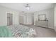 A view of the main bedroom with large windows, ceiling light fixture, and closet at 10189 Magnolia Creek St, Las Vegas, NV 89141