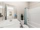 Bright bathroom featuring a large mirror, a toilet, and a shower-tub combo at 103 Reflection Cove Dr, Henderson, NV 89011