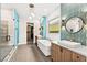 Bright bathroom featuring double sinks, a soaking tub, and a glass-enclosed shower, providing a luxurious and relaxing experience at 103 Reflection Cove Dr, Henderson, NV 89011