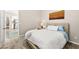 Inviting bedroom with soft carpeting, a comfortable bed, and a view into the living area at 103 Reflection Cove Dr, Henderson, NV 89011