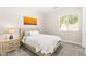 Bright bedroom featuring a comfortable bed, bedside table, and a sunlit window at 103 Reflection Cove Dr, Henderson, NV 89011