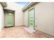Inviting courtyard featuring decorative doors, lush landscaping, and a charming, paved walkway at 103 Reflection Cove Dr, Henderson, NV 89011