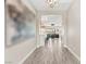 Bright entryway showcasing wood floors, modern artwork, an open floor plan, and mountain views at 103 Reflection Cove Dr, Henderson, NV 89011